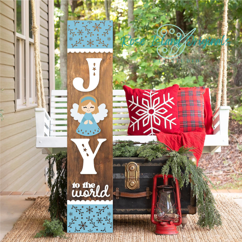 Decorative sign with 'Joy to the World' on a porch with Christmas decorations.