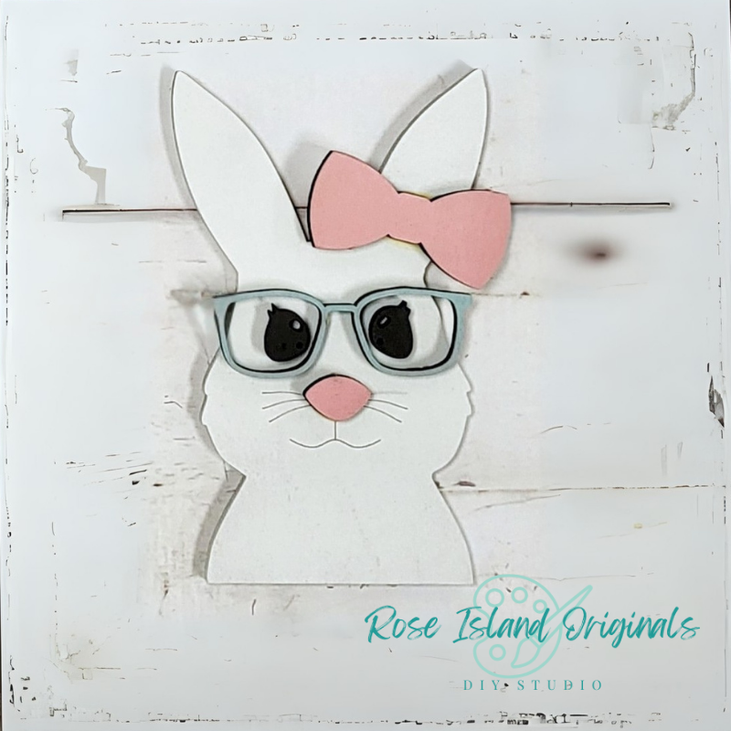 White bunny with glasses and a pink bow on a wooden background, branded 'Rose Island Originals'.