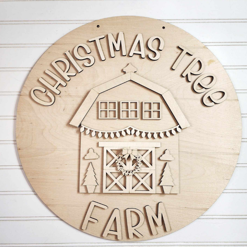 Wooden sign with 'Christmas Tree Farm' text and barn design on a white background