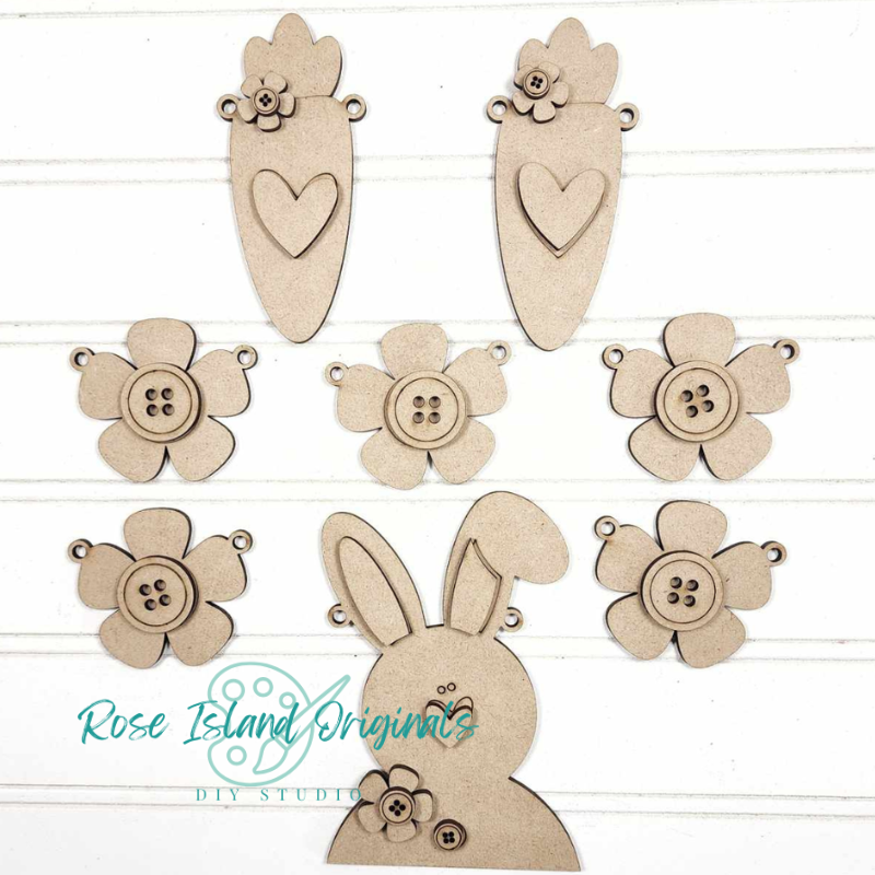 Set of wooden craft shapes with floral, heart, and bunny designs on a white background.