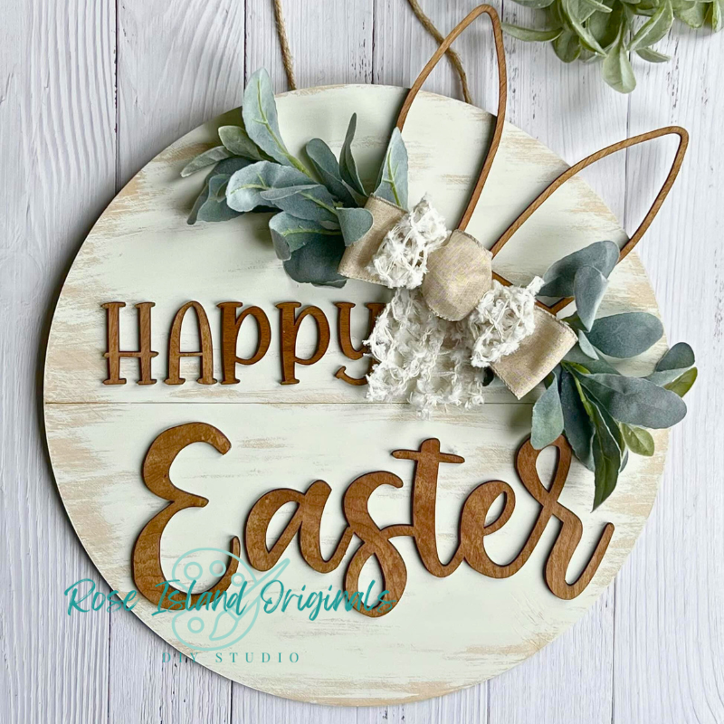 Decorative sign with 'Happy Easter' text, bunny ears, and floral elements on a wooden background.