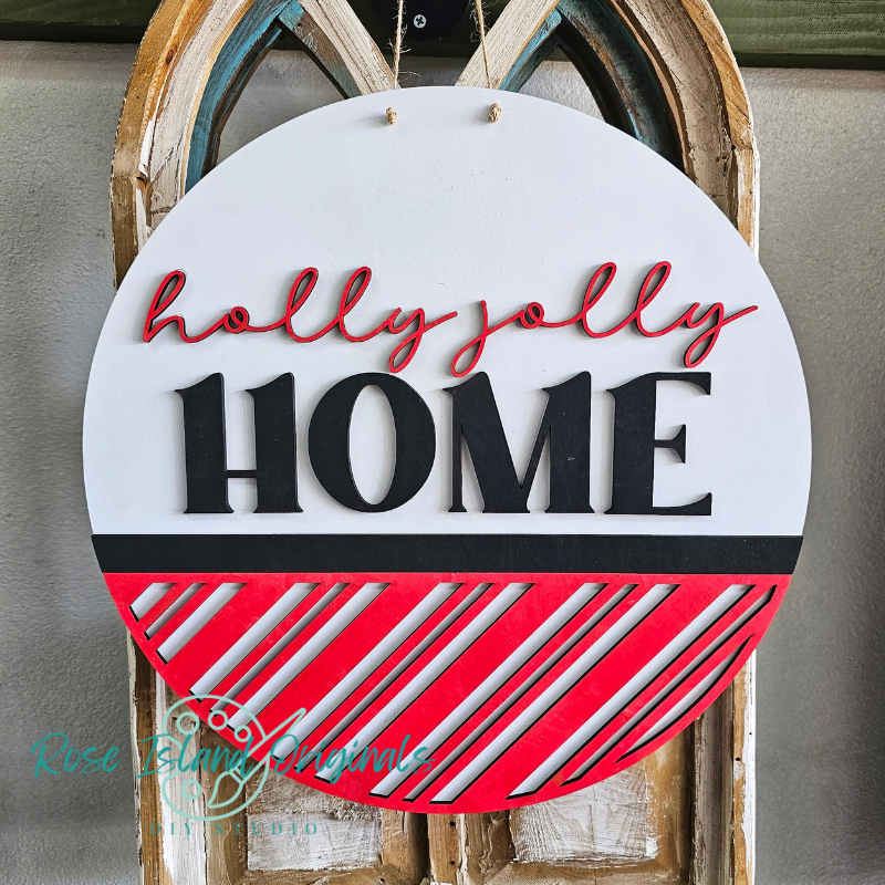 Decorative sign with 'holly jolly HOME' text on a white background with red and black accents.
