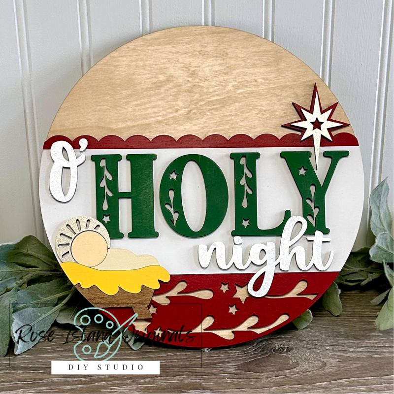 Decorative sign with 'O Holy Night' text and Christmas elements on a wooden background.