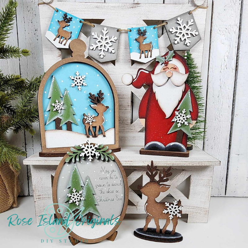 Wooden Christmas decorations including Santa Claus, reindeer, and snowflakes on a white wooden background.