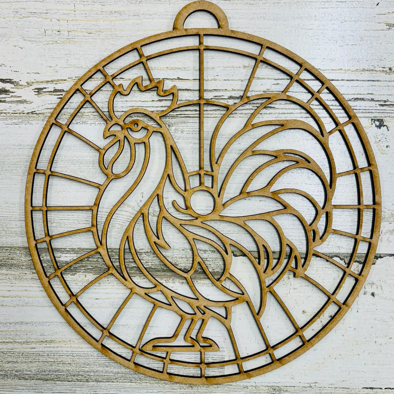 Decorative metal rooster design on a wooden surface