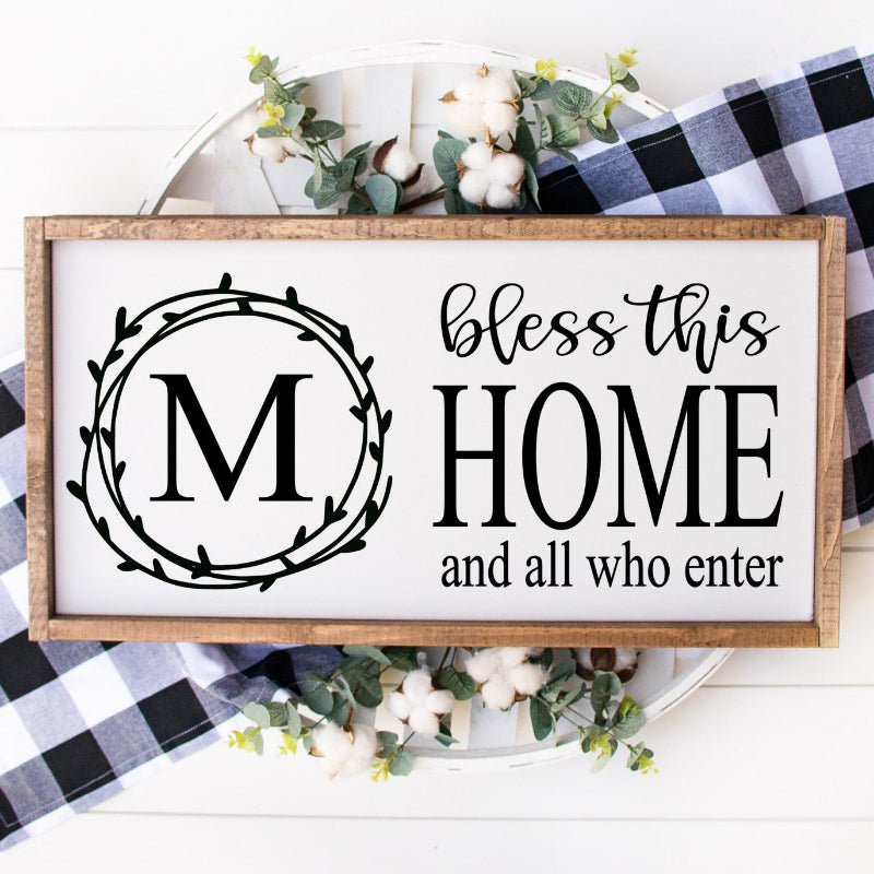 Decorative sign with 'bless this home and all who enter' text on a checkered fabric background