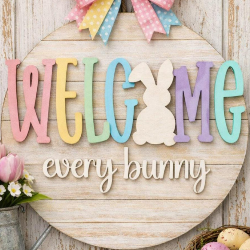 Decorative sign with 'Welcome every bunny' text on a wooden background.