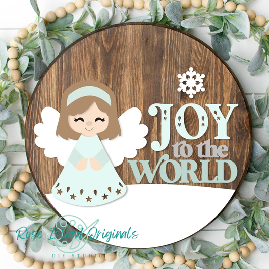 Decorative sign with an angel and 'Joy to the World' text, surrounded by greenery and beads.