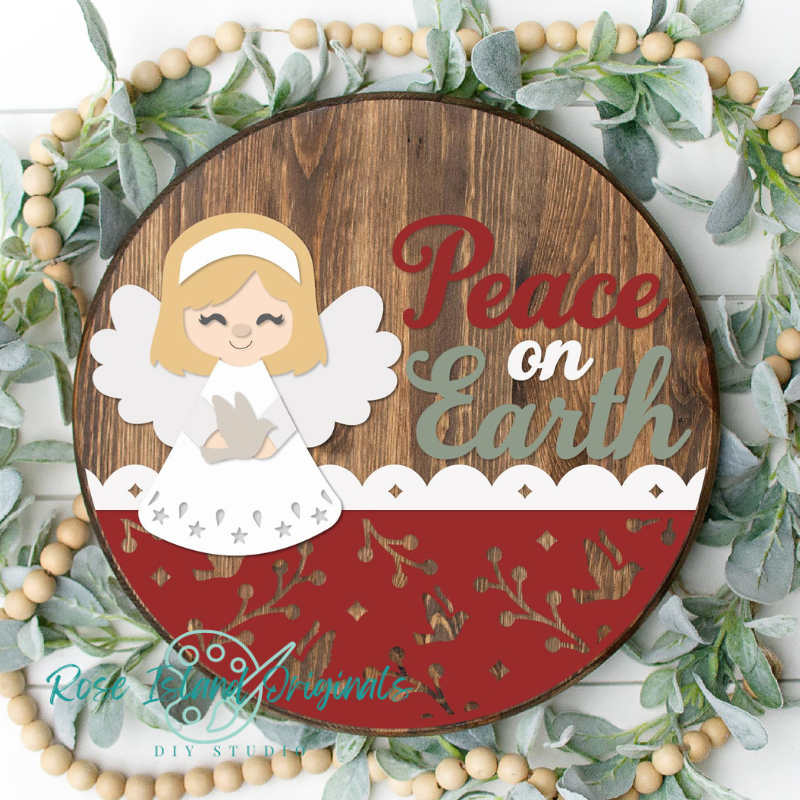 Round wooden sign with angel and words peace on earth
