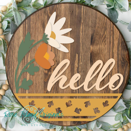 Wooden round sign with floral design and 'hello' text, surrounded by greenery and beige beads.