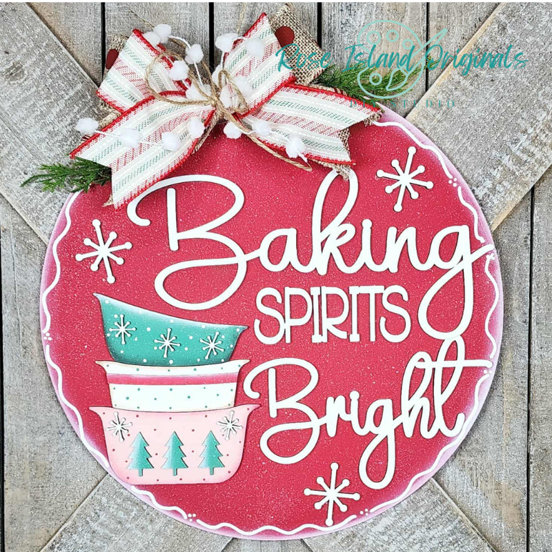 Decorative sign with 'Baking Spirits Bright' text on a red background, featuring Christmas elements.