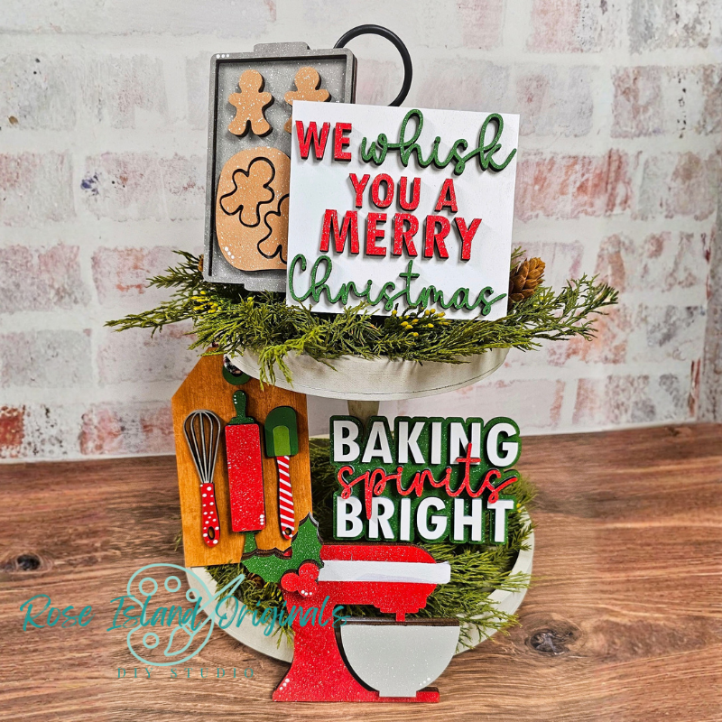 Decorative sign with Christmas-themed text and baking elements on a wooden surface.