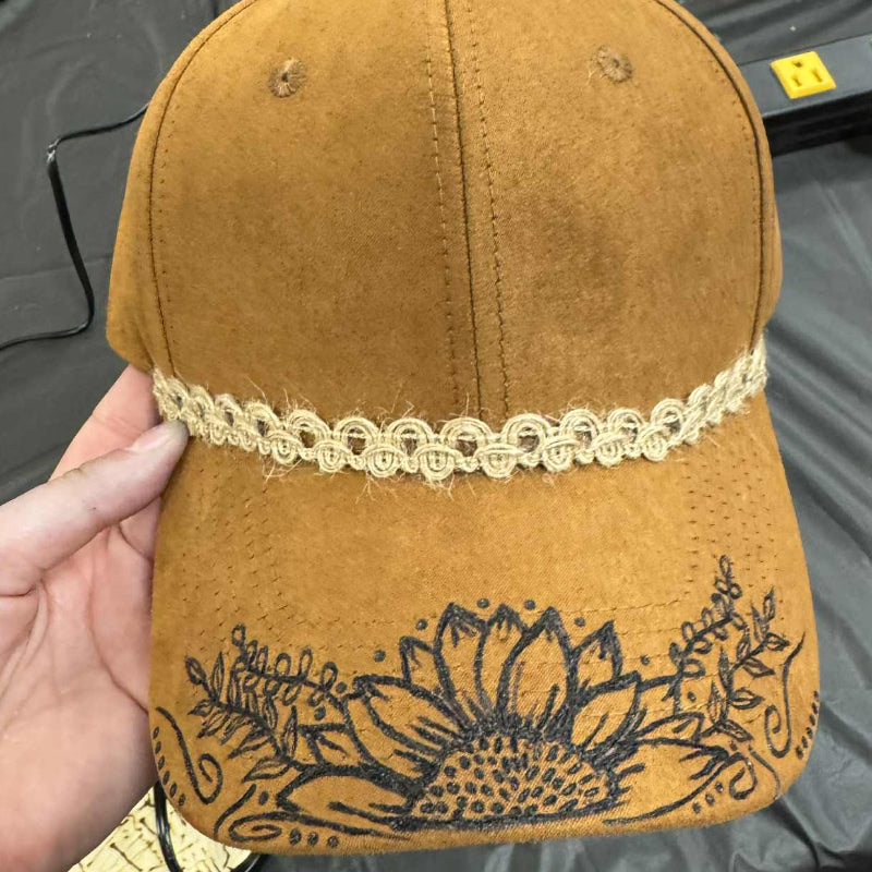 Baseball style ball cap with lace detail and sunflower design on the bill
