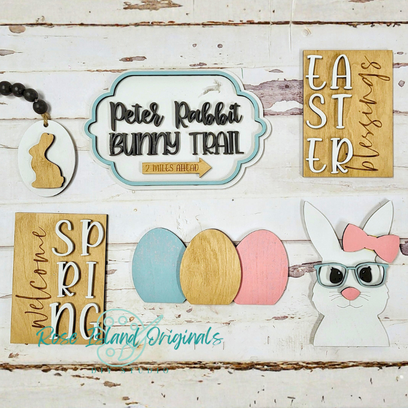 Easter-themed wooden signs and decorations on a rustic wooden background
