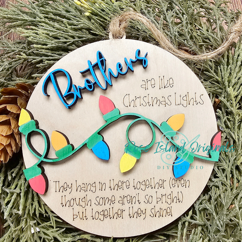 Decorative wooden ornament with Christmas lights and text on a green leaf background