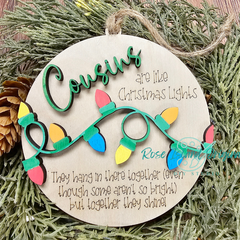 Decorative round ornament with Christmas lights design and text on a green leaf background