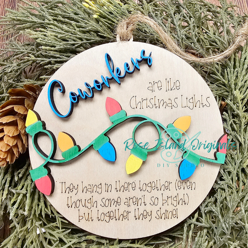 Decorative Christmas ornament with string lights and text on a green leaf background