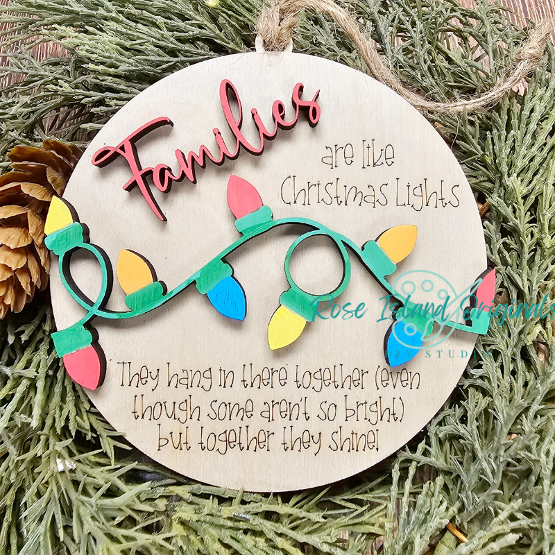 Decorative Christmas ornament with text and lights on a green leaf background