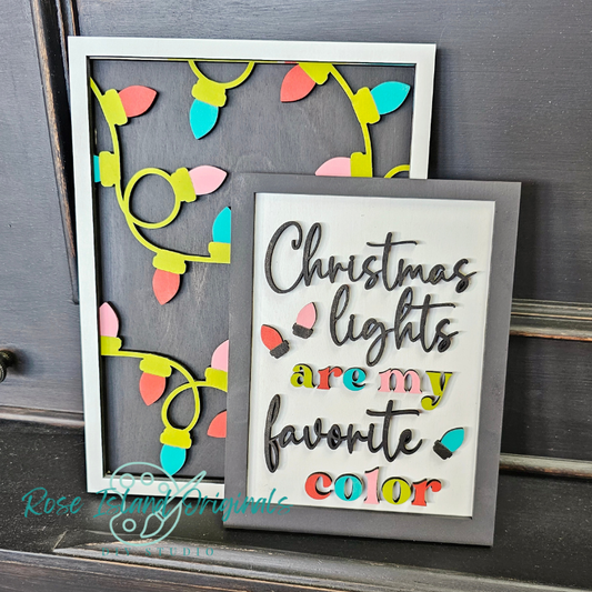Decorative sign with colorful Christmas lights and text on a gray background