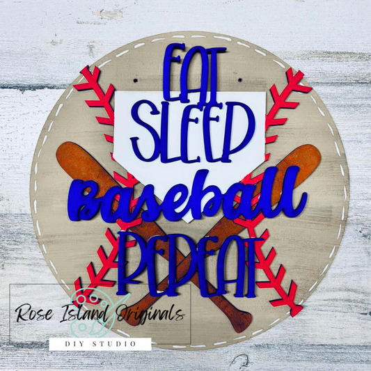 Decorative sign with 'Eat Sleep Baseball Repeat' text on a wooden background, featuring baseball bats and balls.
