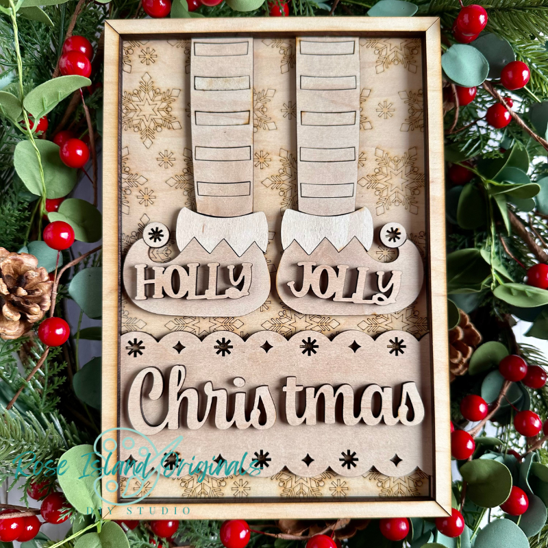 Wooden Christmas decorations with 'Holly Jolly' text, surrounded by festive greenery and berries.