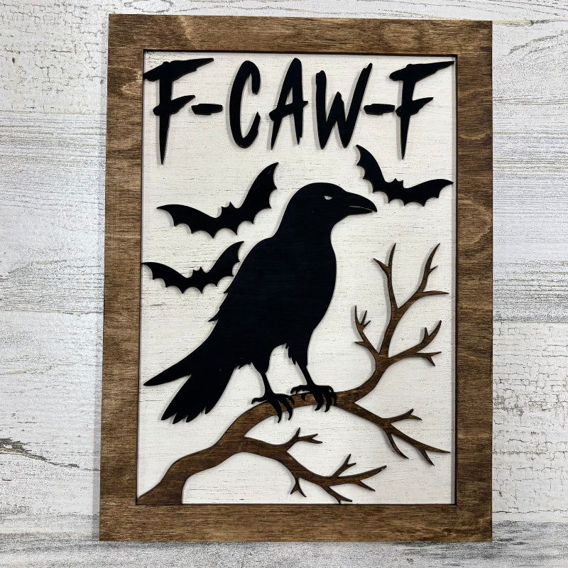Wood sign with black bird and F-Caw-F