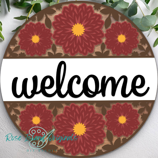 Round decorative sign with red mum flowers and the word 'welcome' on a white background.
