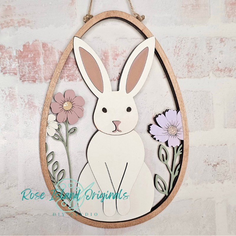 Decorative wall art with a rabbit and flowers on a textured background