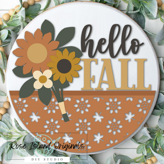 Decorative sign with 'hello FALL' text and autumn-themed design, surrounded by greenery.