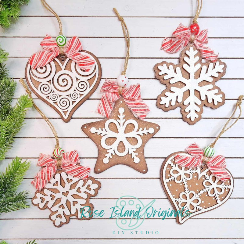 Decorative Christmas ornaments shaped like gingerbread cookies on a wooden surface with 'Rose Island Originals' branding.