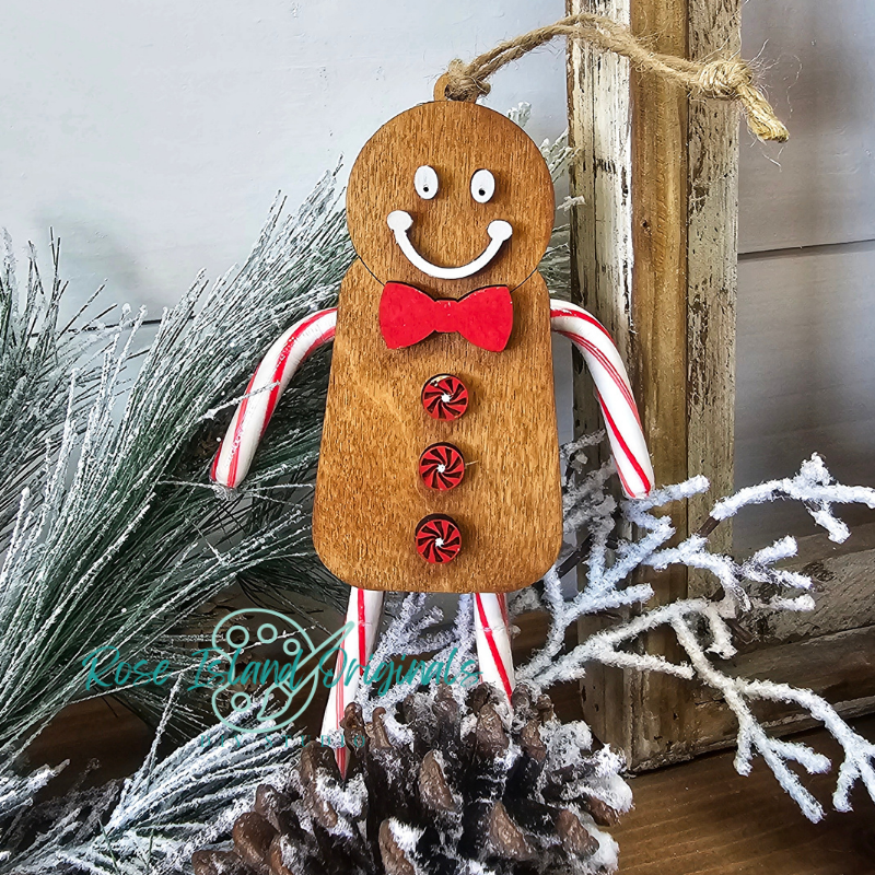Wooden gingerbread man ornament with candy cane arms on a decorative background