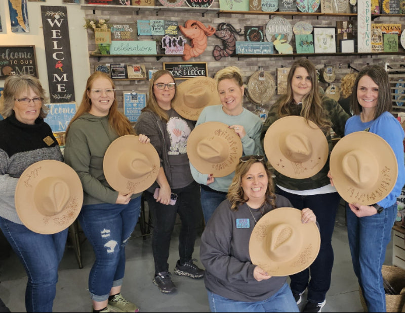 Group of ladies proudly displaying their hand burned ranch style hats.