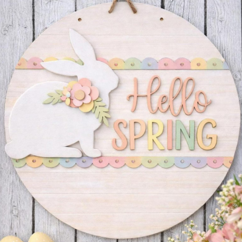 Decorative sign with a bunny and 'Hello Spring' text on a wooden background