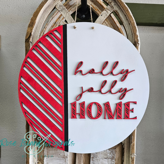 Decorative sign with 'holly jolly HOME' text on a white background with red and black accents, hanging on a wooden wheel.