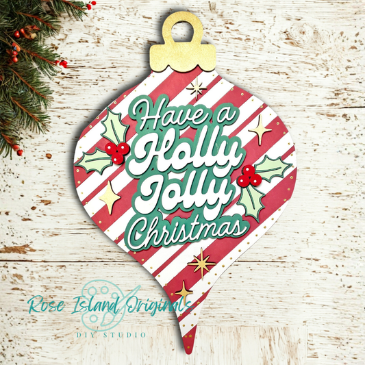 Decorative Christmas ornament with 'Have a Holly Jolly Christmas' text on a wooden surface.