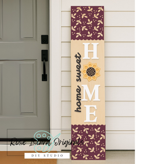 Decorative porch sign with 'Home Sweet Home' text and floral patterns near a door.