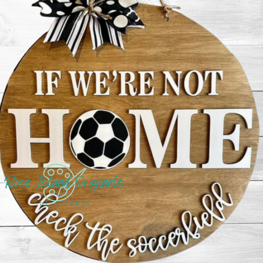 Wooden sign with soccer ball design and text If We're Not Home Check the Soccer Field