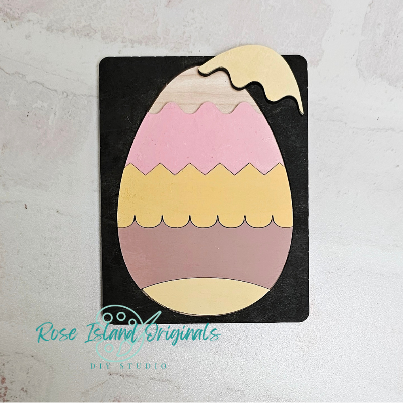 Colorful egg-shaped wooden puzzle on a white background with 'Rose Island Originals' branding.