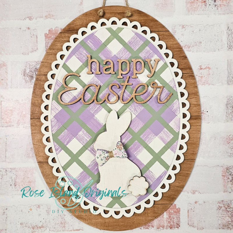 Decorative Easter sign with a bunny and 'Happy Easter' text on a plaid background.