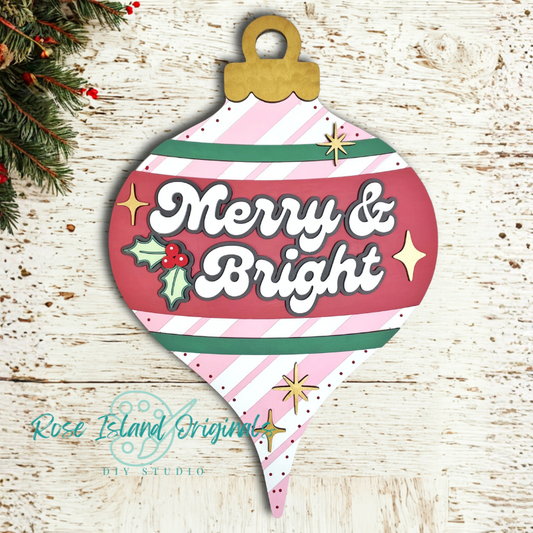 Decorative Christmas ornament with 'Merry & Bright' text on a wooden surface.