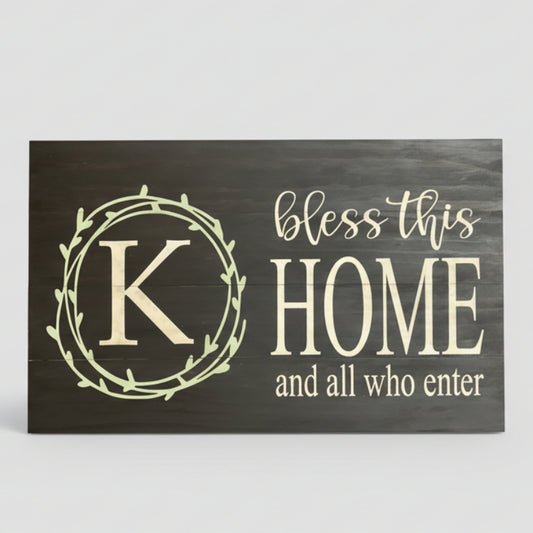 Wood sign with letter K and words bless this home and all who enter