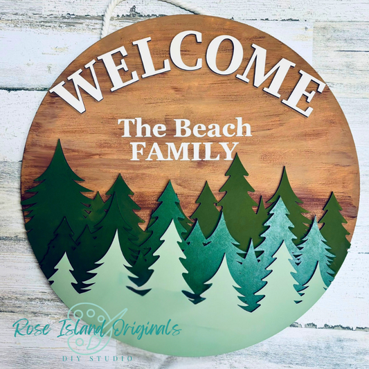 Wooden welcome sign with trees and 'The Beach Family' text on a wooden background