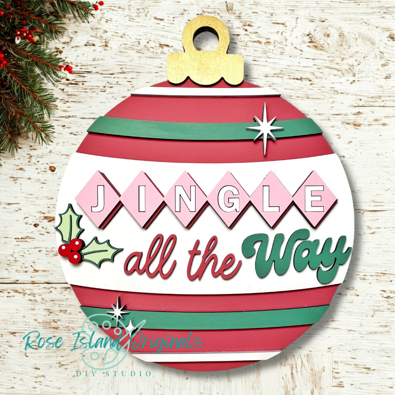 Decorative Christmas ornament with 'Jingle all the Way' text on a wooden background.