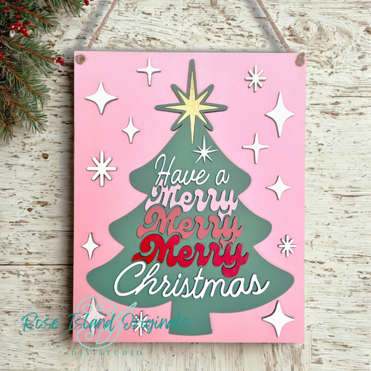 Decorative Christmas sign with a tree design and text on a pink background.