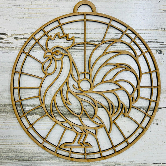 Decorative metal rooster design on a wooden surface