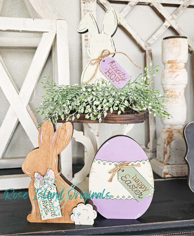 Decorative Easter items including a wooden bunny, purple egg with 'Happy Easter' tag, and potted plant on a rustic shelf.