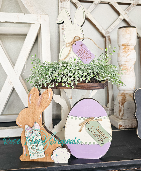 Decorative Easter items including a wooden bunny, purple egg with 'Happy Easter' tag, and potted plant on a rustic shelf.