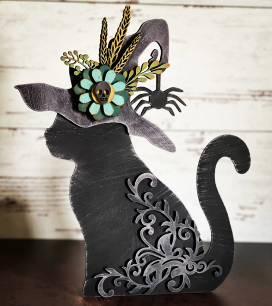 Decorative cat silhouette with floral headpiece on a wooden background