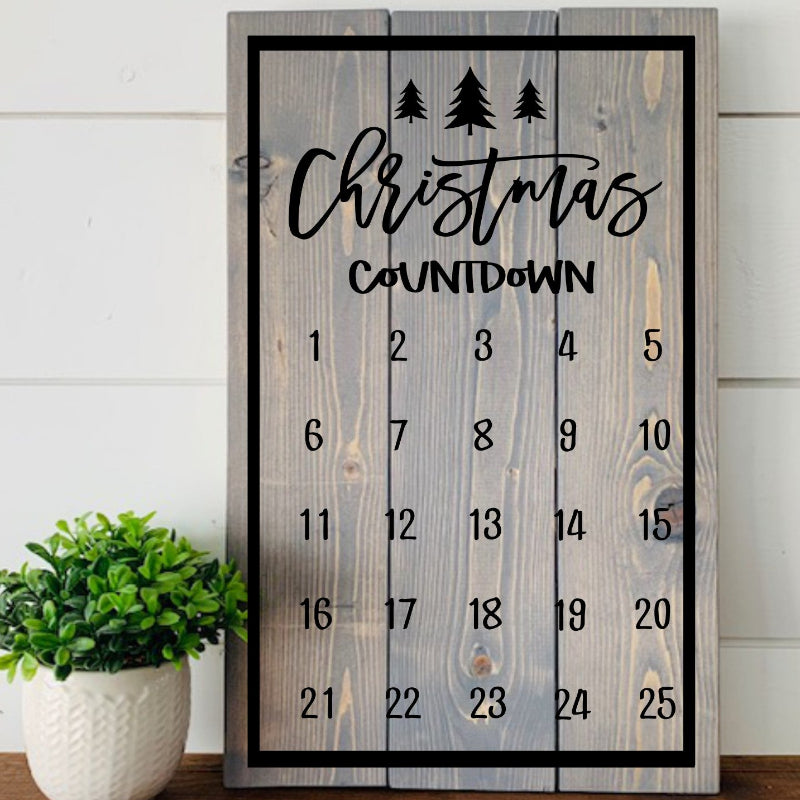 Wooden Christmas countdown calendar with decorative elements on a wooden surface.