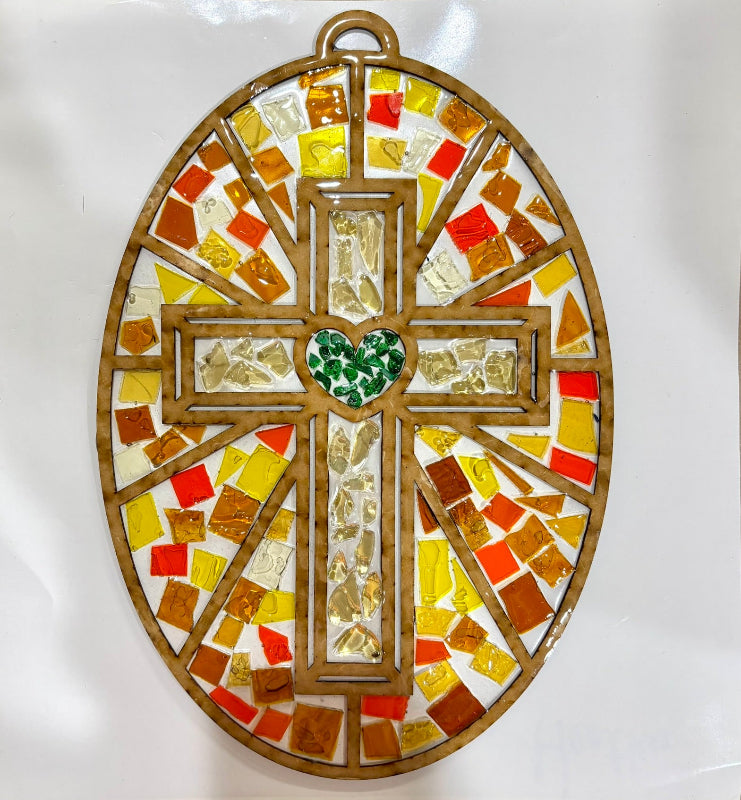 Mosaic cross with colored tiles on a white background